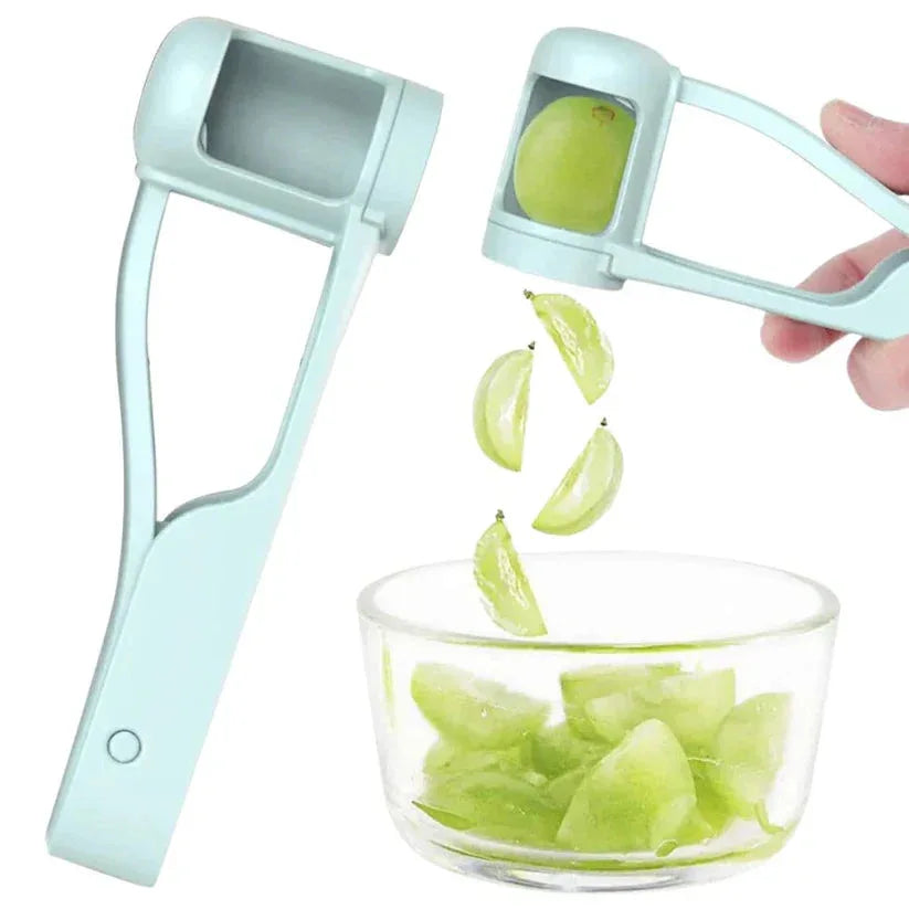 Green fruit being sliced by a blue fruit slicer with a glass bowl below.

