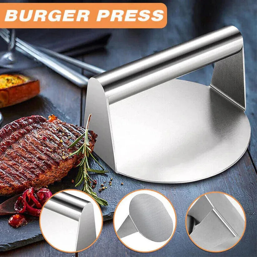 Metal burger press on a grill with cooked burger and ingredients, featuring close-up details.

