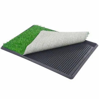 Pet training pad with green grass-like surface and black textured surface on a white background


