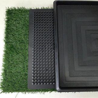 Green artificial grass, textured black mat, and square black tray on a white background

