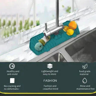 Green dish drying mat with squeegee on a kitchen sink

