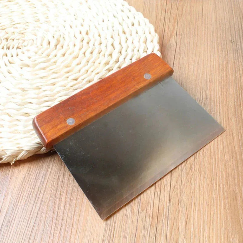 Metal blade with wooden handle on a wooden surface

