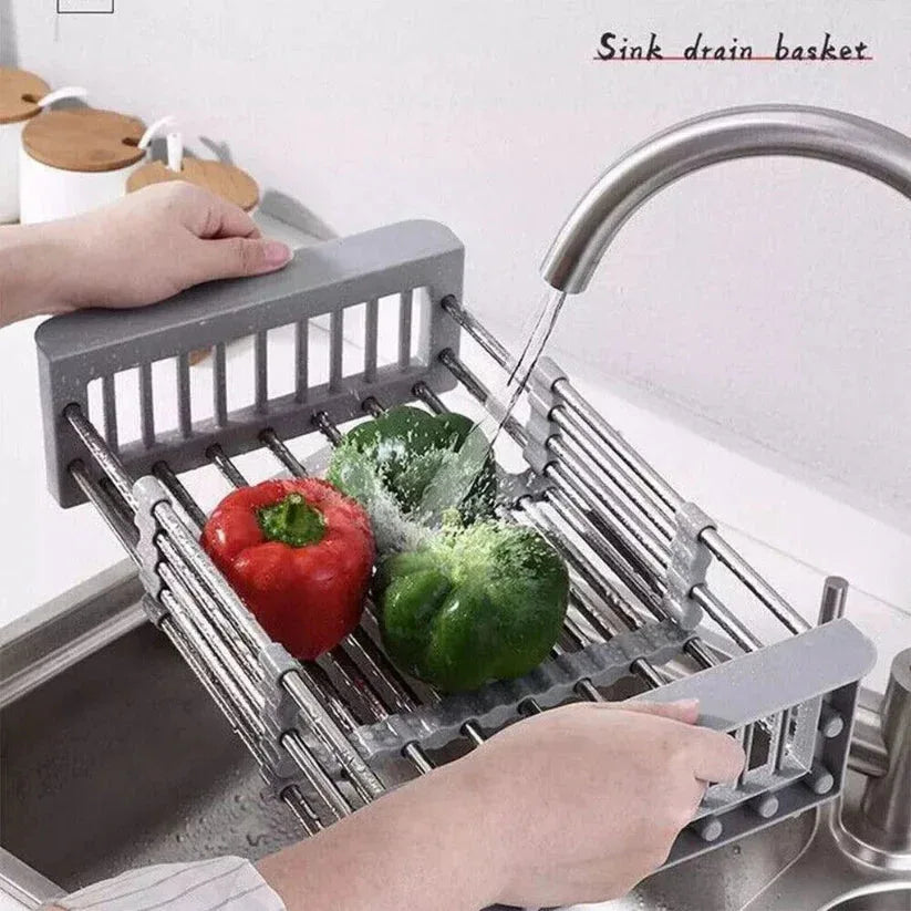 Sink drain basket with vegetables being washed under running water

