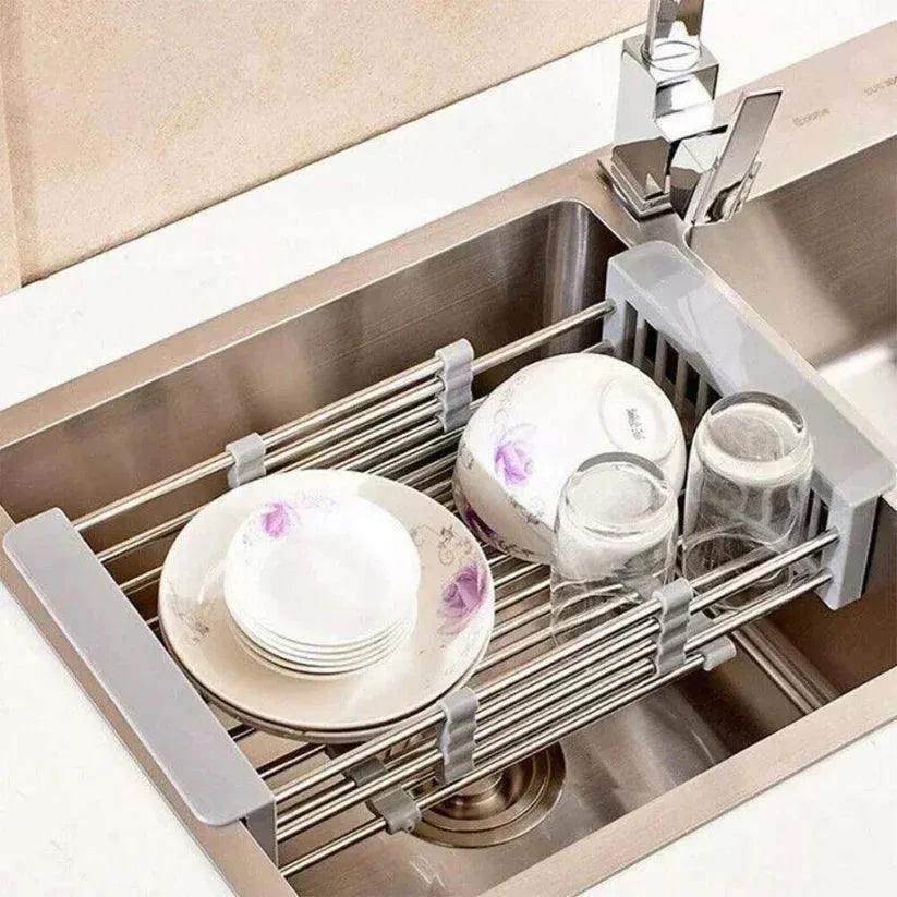 Dish drying rack over a kitchen sink with dishes on it

