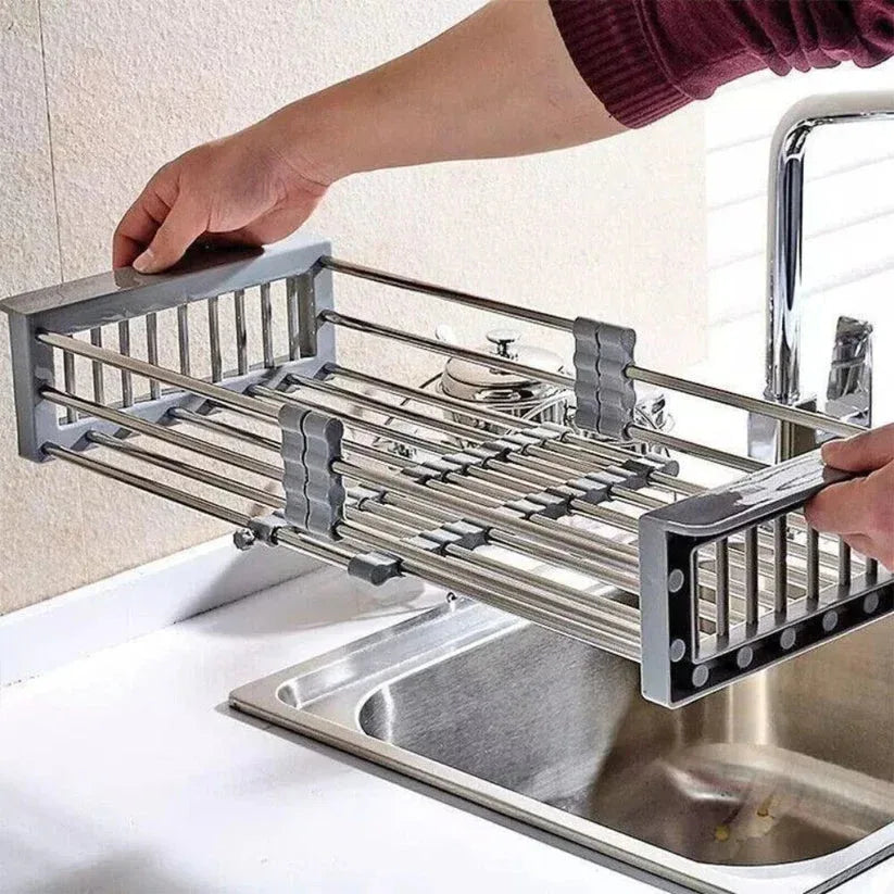 Person using a stainless steel dish rack over a sink

