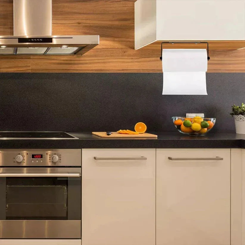 Modern kitchen with stainless steel appliances, wooden cabinets, and a fruit bowl on the counter.

