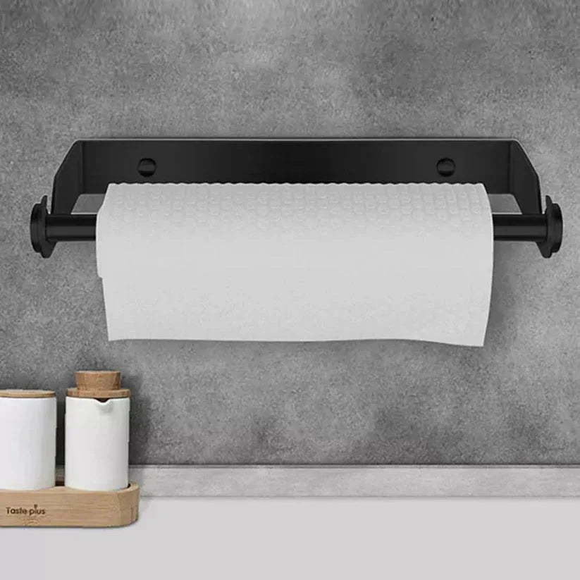 Black paper towel holder with a roll of paper towels on a gray wall.

