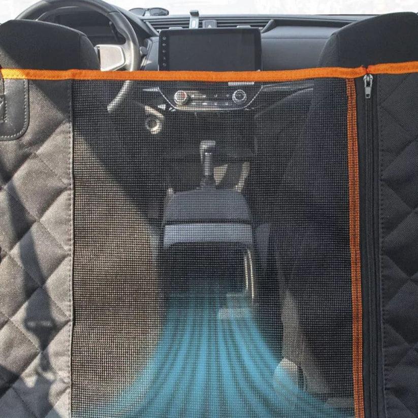 Car interior with a black and orange pet barrier

